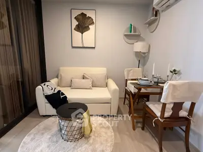 Cozy living room with modern decor and dining area, perfect for urban living.