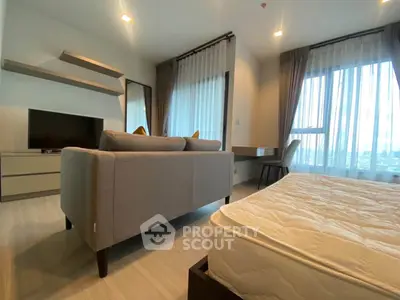 Modern living room with stylish furniture and large windows offering natural light.