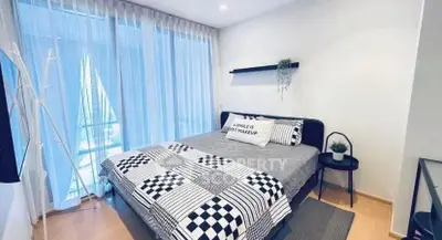 Modern bedroom with stylish decor and large windows for natural light