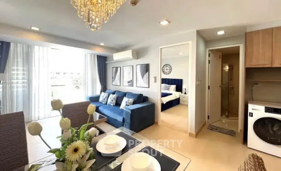 Modern open-plan living room with elegant decor and natural light