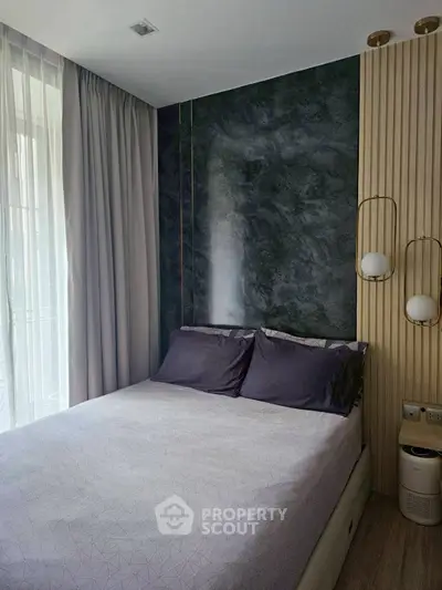 Modern bedroom with stylish accent wall and elegant lighting