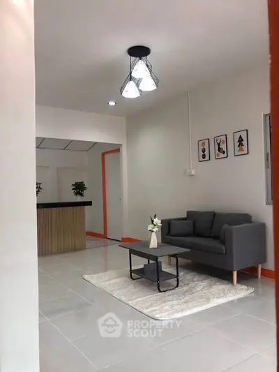 Modern living room with sleek gray sofa and stylish lighting