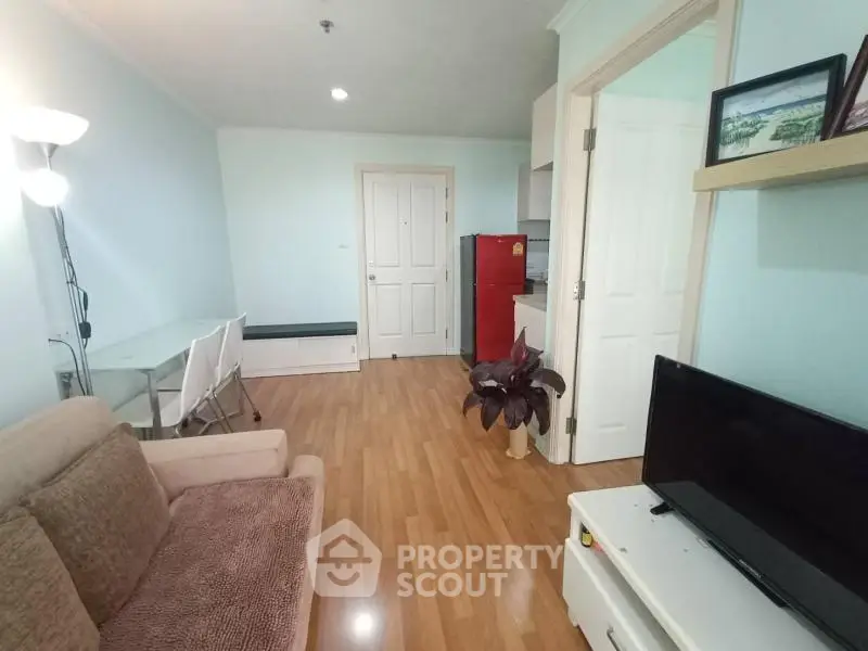 Cozy living room with modern decor and open kitchen layout in a stylish apartment.