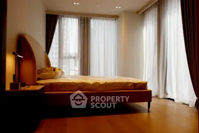 Luxurious bedroom with elegant curtains and modern lighting