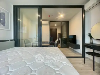 Modern bedroom with glass partition and stylish decor in a contemporary apartment.