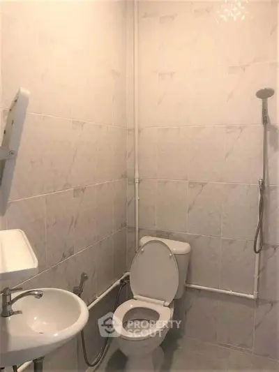 Compact bathroom with shower and toilet in minimalist design