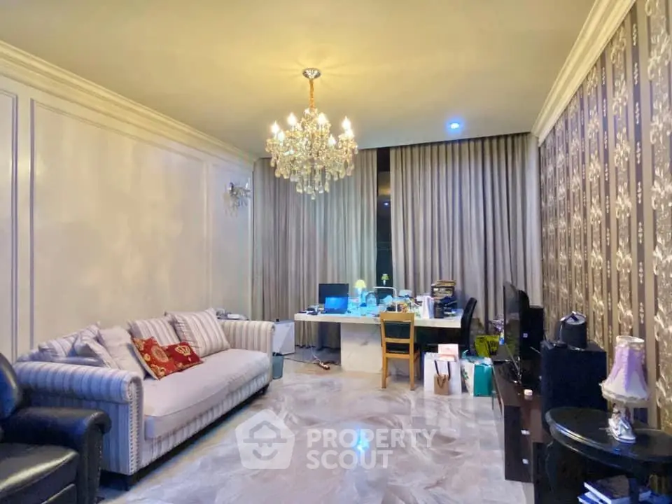 Elegant living room with chandelier and stylish decor, perfect for modern living.