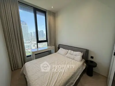 Modern bedroom with city view, featuring a cozy bed and large window for natural light.