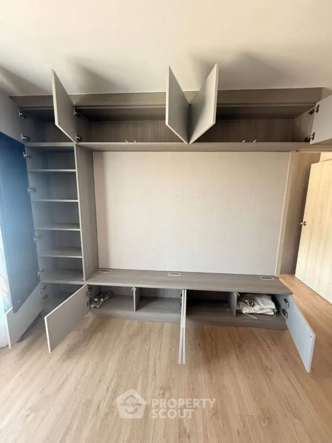 Spacious modern storage unit with open cabinets and shelves in a bright room.