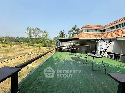 Spacious outdoor balcony with scenic garden view in a modern home