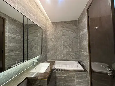 Luxurious modern bathroom with elegant marble tiles and built-in bathtub