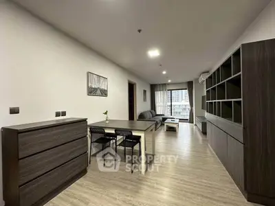 Modern living room with sleek furniture and open layout in urban apartment.