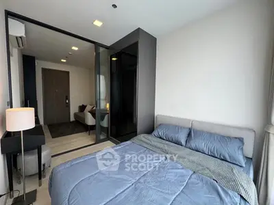 Modern bedroom with glass partition and cozy living area in stylish apartment