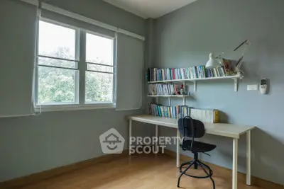 Bright study room with large window and built-in bookshelves