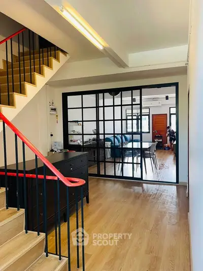 Modern interior with open layout, wooden floors, and stylish staircase in a contemporary home.