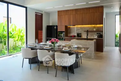 Luxurious modern kitchen with elegant dining area and garden view
