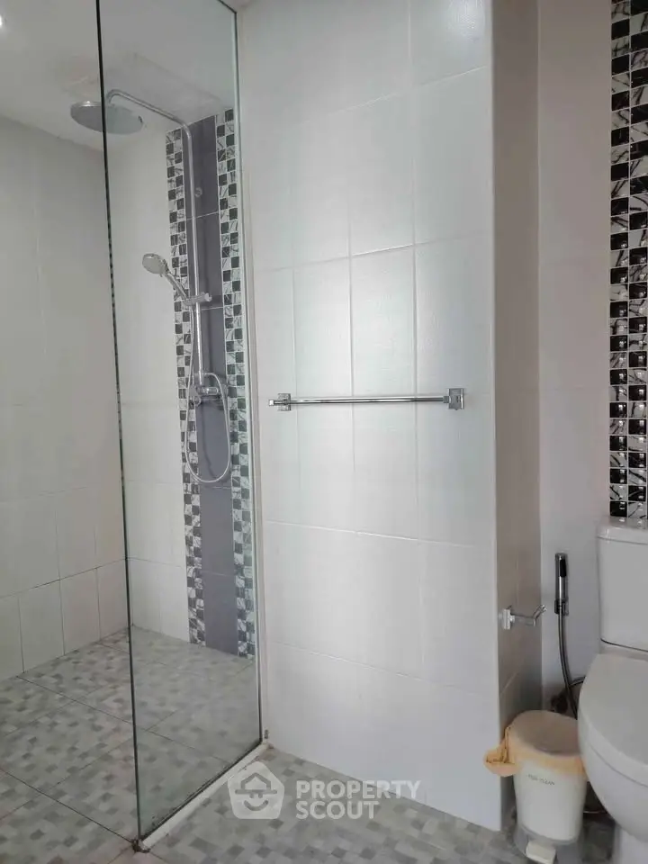Modern bathroom with glass shower and stylish tile design