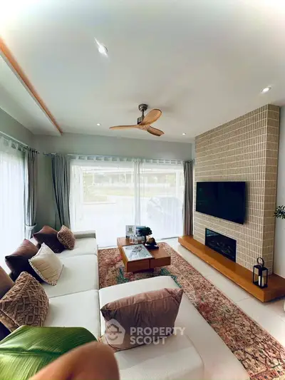 Stylish living room with modern decor, large windows, and cozy seating area.