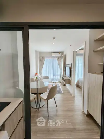 Modern open-plan living room with dining area and natural light