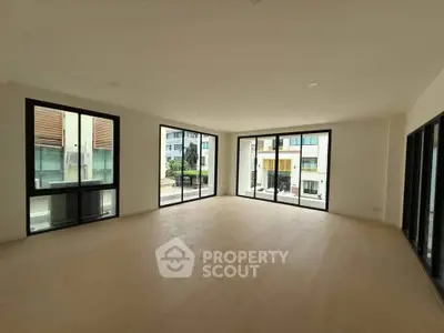 Spacious corner unit with large windows and abundant natural light in modern apartment.