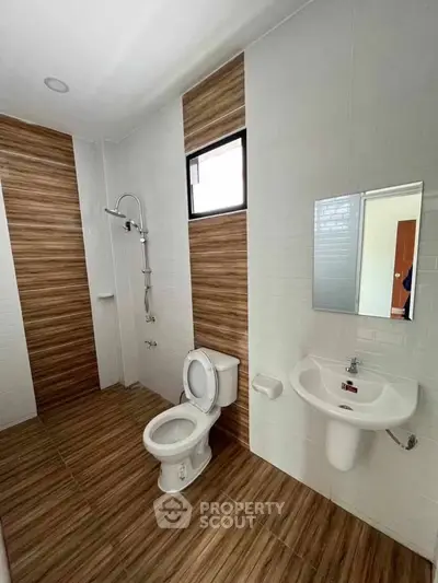 Modern bathroom with wooden tile accents and sleek fixtures