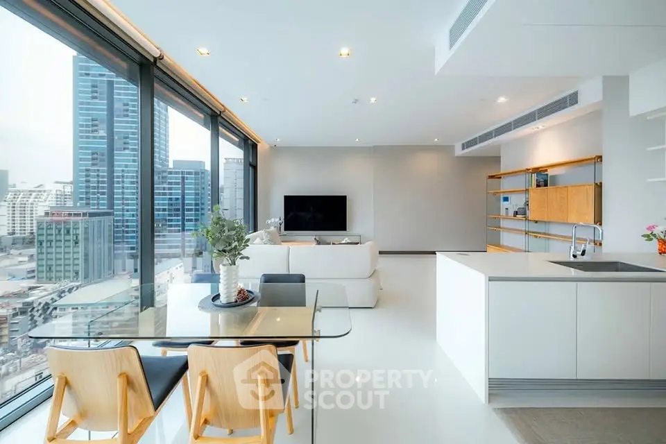 Luxurious open-plan living room with stunning city views and modern kitchen.