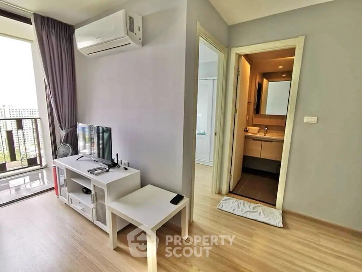 Modern apartment living room with balcony and bathroom access