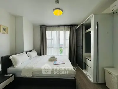 Modern bedroom with large bed and stylish wardrobe in bright apartment