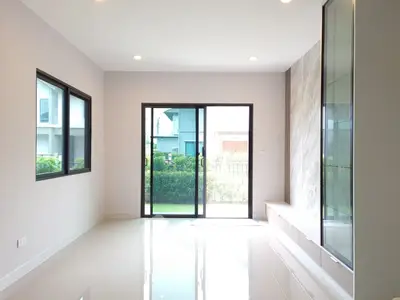 Bright and spacious living room with large windows and garden view