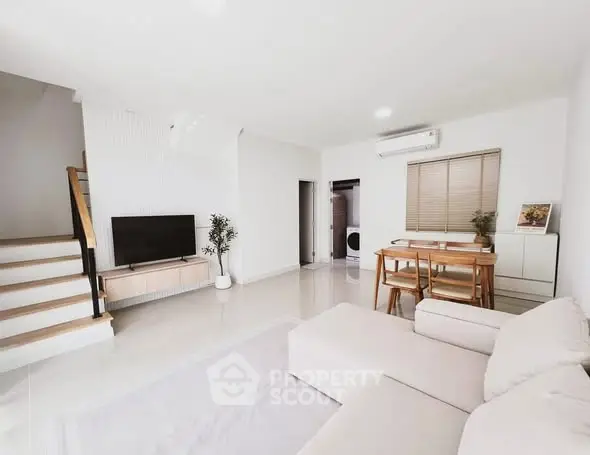 Spacious modern living room with neutral tones and stylish furniture