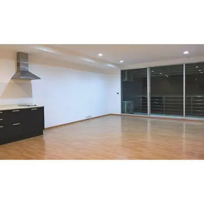 Spacious open-plan living room with modern kitchen and balcony access.
