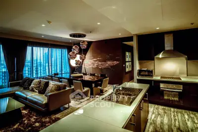 Luxurious open-plan living room and kitchen with modern decor and city view.