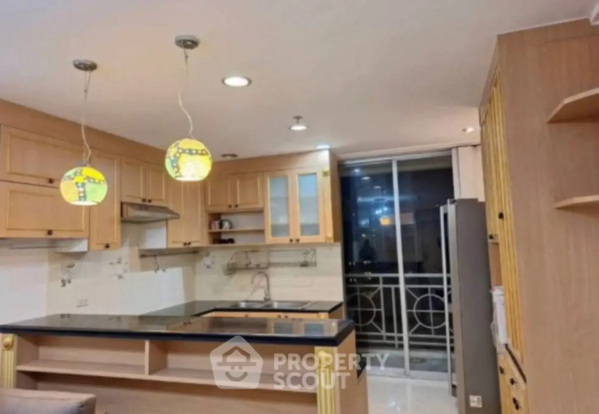 Modern kitchen with stylish pendant lights and open layout