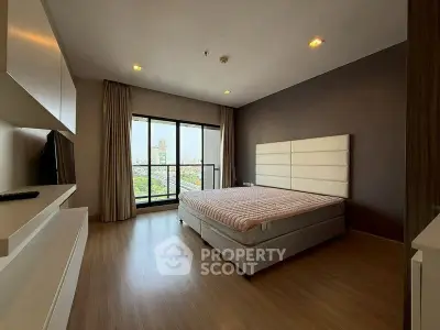 Spacious bedroom with city view and modern decor in luxury apartment