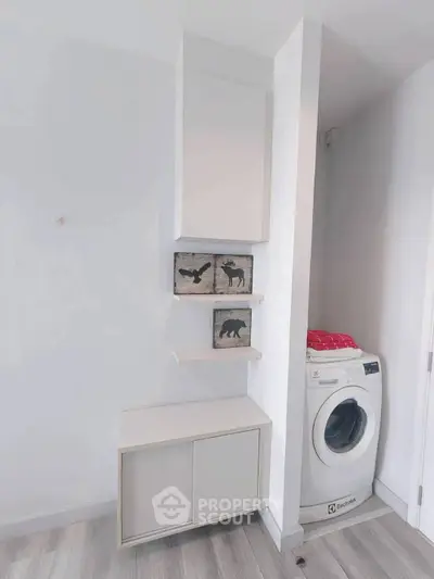 Modern laundry area with washing machine and stylish shelving