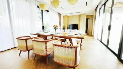 Luxurious open-plan living room with elegant dining area and floor-to-ceiling windows.