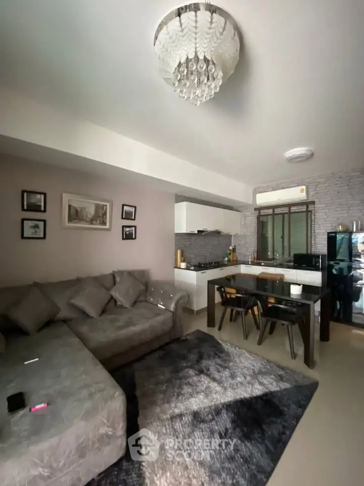 Stylish living room with modern decor and open kitchen layout