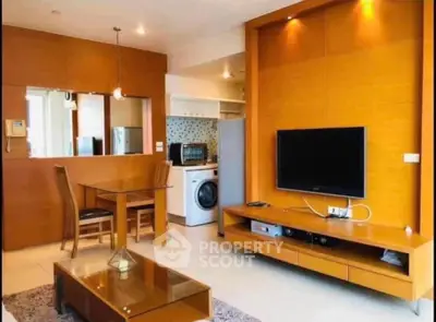 Modern living room with stylish furniture and integrated kitchen appliances