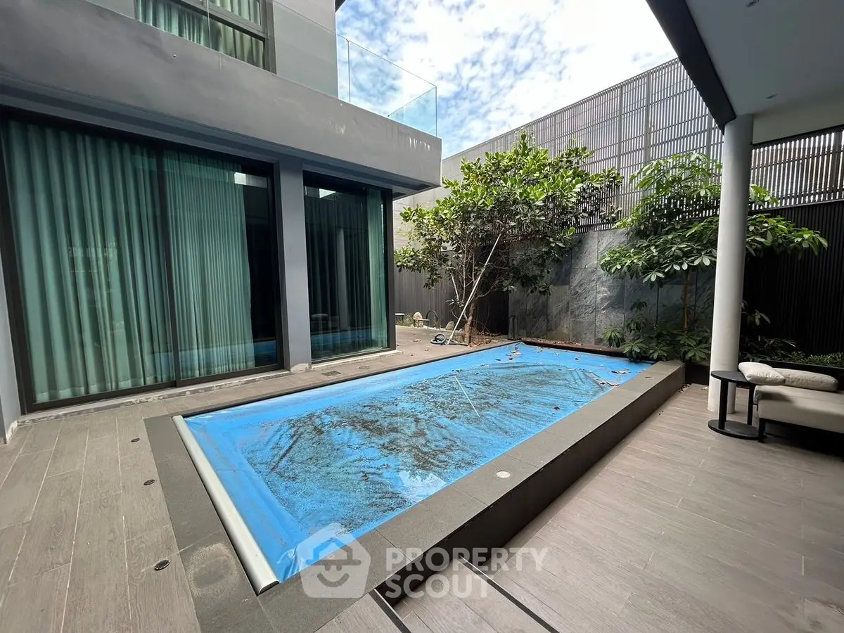 Modern home with sleek pool and lush garden, perfect for relaxation and entertainment.