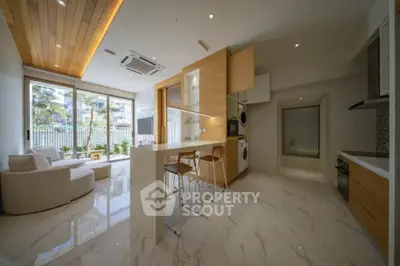 Modern open-plan living room with sleek kitchen and stylish decor