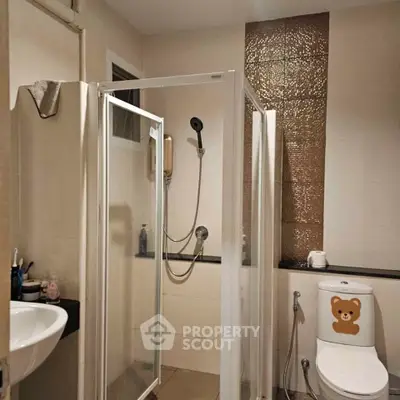 Modern bathroom with glass shower enclosure and stylish tile accents
