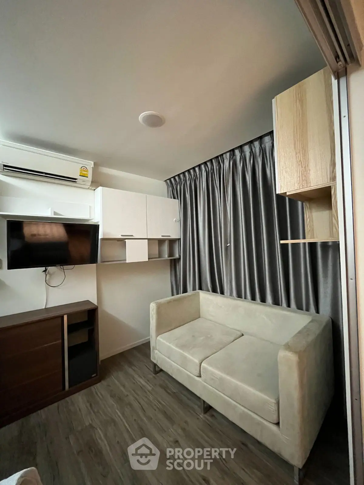Modern compact living room with sleek furniture and stylish curtains