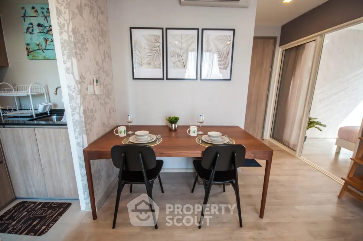 Chic dining area with modern decor and wooden table in stylish apartment.
