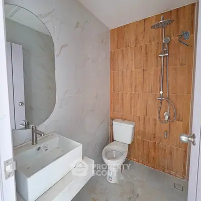 Modern bathroom with stylish shower and elegant sink in contemporary home.