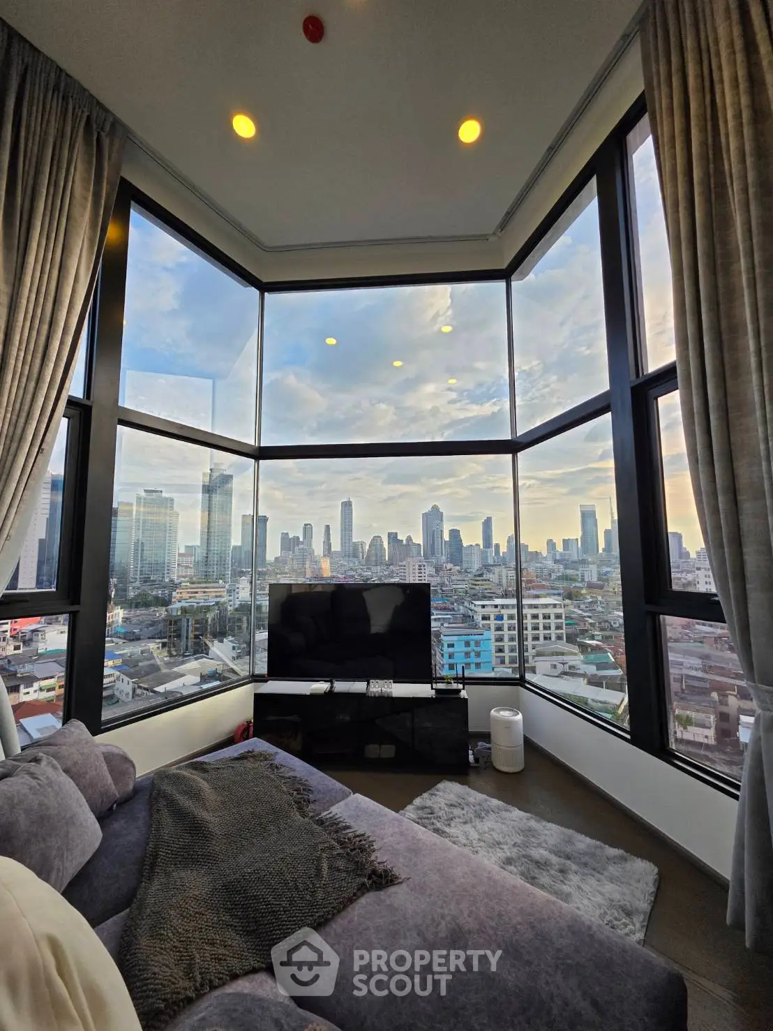 Luxurious corner unit with panoramic city views from a stylish living room.
