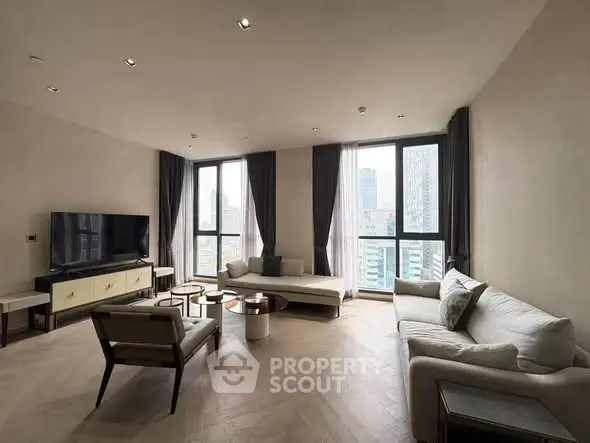 Spacious modern living room with large windows and city view, featuring elegant furniture and natural light.
