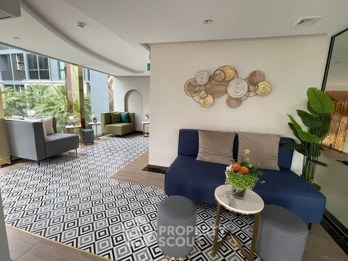 Luxurious modern living room with stylish decor and expansive windows overlooking greenery.