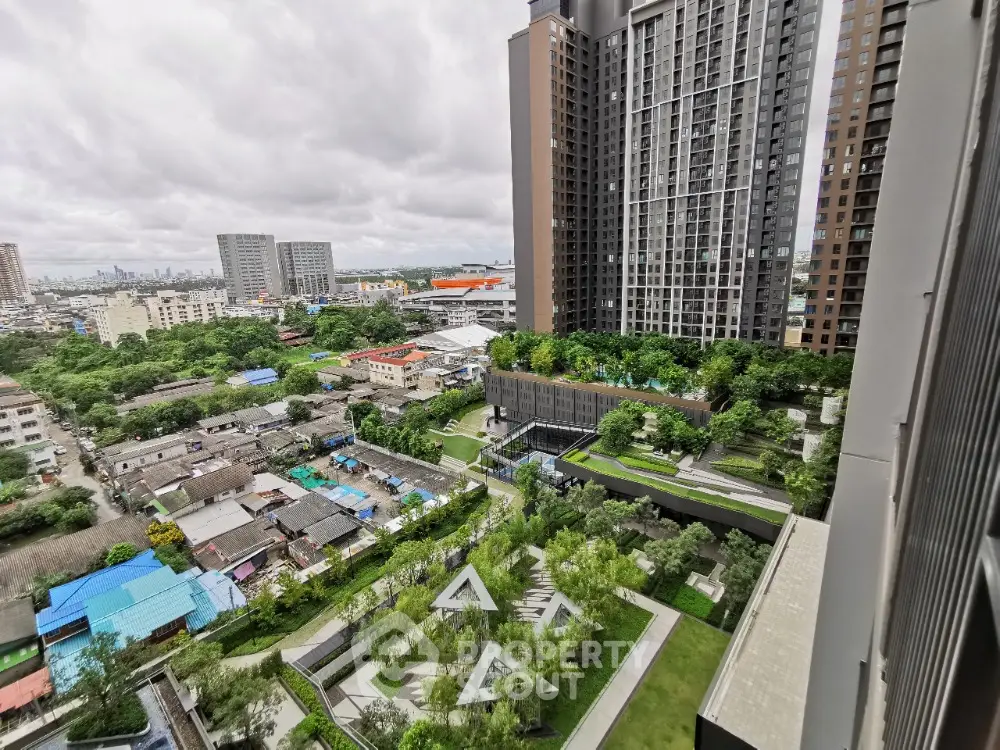 Stunning high-rise apartment view with lush gardens and cityscape backdrop.