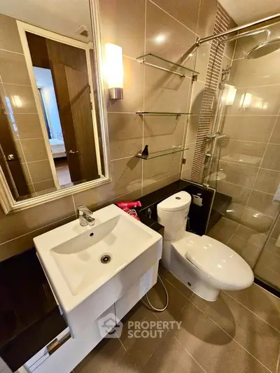 Modern bathroom with sleek fixtures and glass shower enclosure