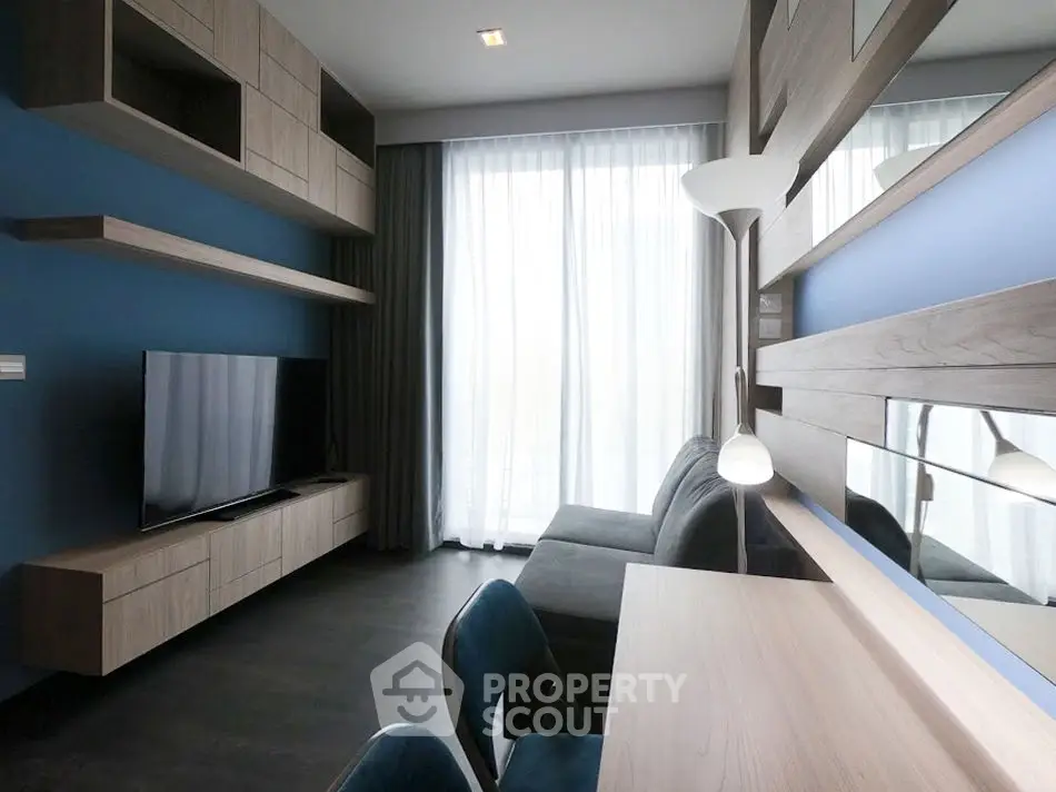 Modern living room with sleek furniture and large window for natural light